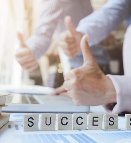 “Success” word on business working table. Wooden cross word alphabet “Success”. Business teamwork success concept.